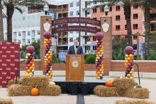 Kyle Clark speaking at podium from afar