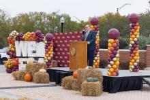 Kyle Clark speaking at podium from angle