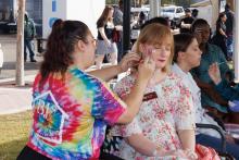 woman getting her face painted
